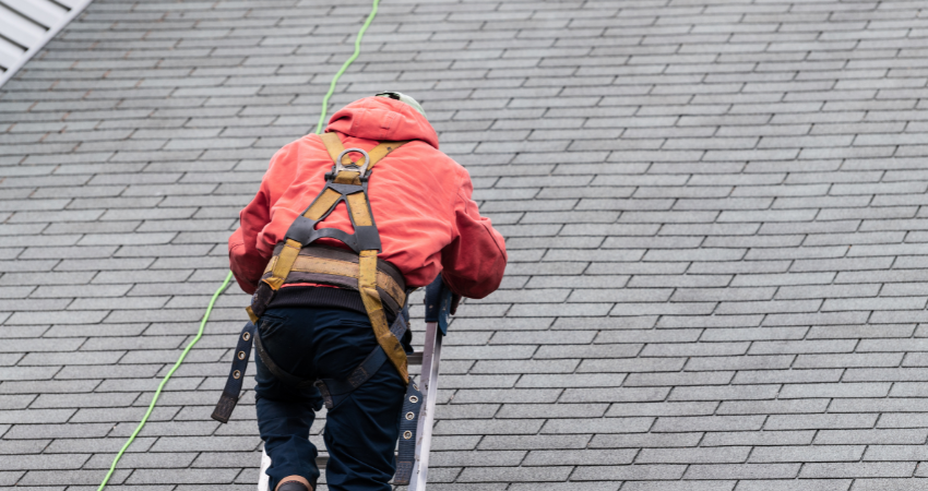 roofer climbing ladder to roof